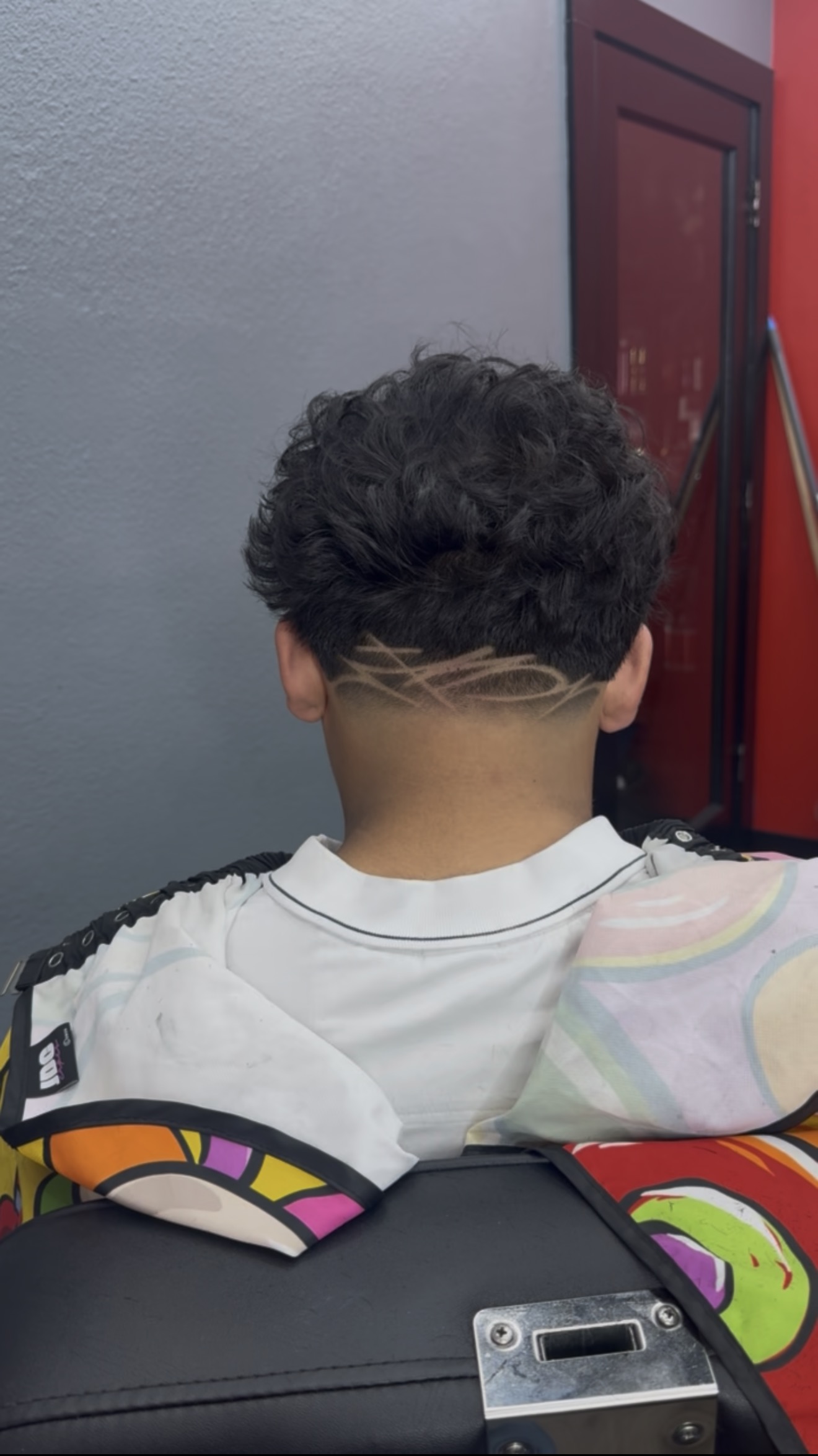 Curly top with custom wave design taper